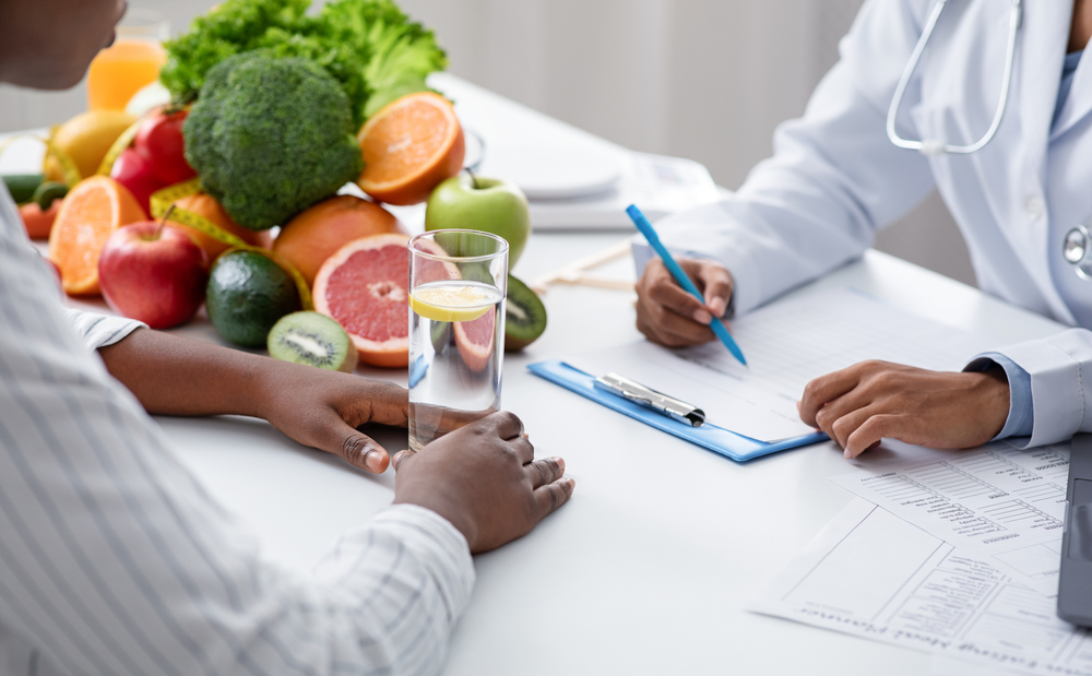 nutritionist works with a client to develop a meal plan and teach them about health and wellness